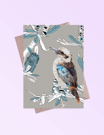 Greeting card printed in Australia. Made with recycled card. It has an image of a kookaburra and banksia flowers on the front and is blank inside.