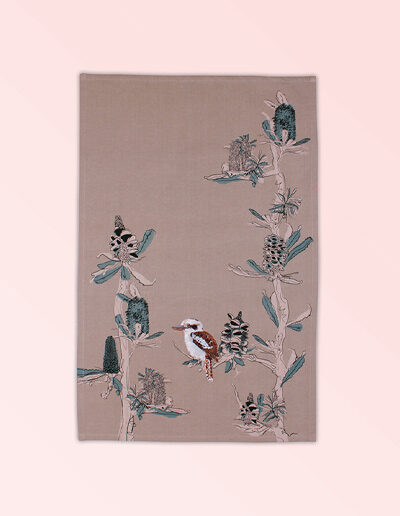 Tea towel with embroidered kookaburra sitting in screen printed banksia trees. The fabric is a natural Australian organic cotton.