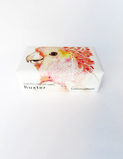 Bar of soap wrapped in paper with a Pink Cockatoo design.