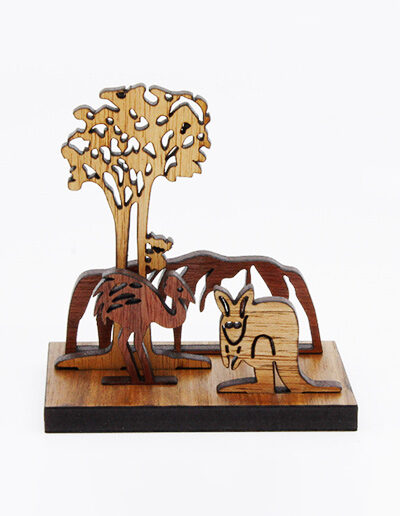 A wooden mini landscape of an Australian image with Uluru, a kangaroo, an emu and a koala in a gum tree. Four wooden images sit into a wooden base to make up the 3D landscape.