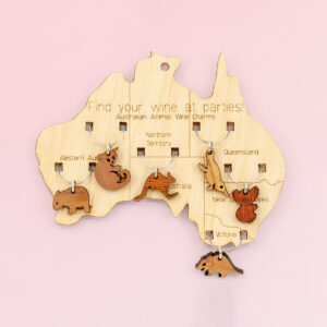 Wooden map of Australia which presents on it 6 wine glass charms of six different animals. One is attached to the map in each state.