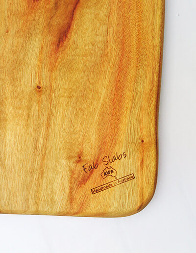 Close up of Fab Slabs brand in the corner of the wooden chopping board