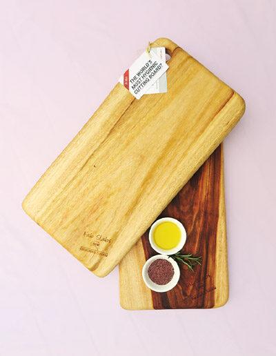 Two medium wooden chopping boards with a dish of salt & a dish of oil