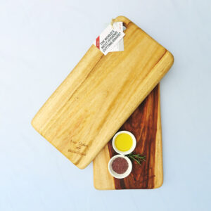 Two medium wooden chopping boards with a dish of salt & a dish of oil