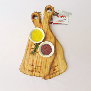 Two small paddle chopping boards with a dish of salt & a dish of oil