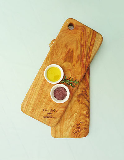 Two small chopping boards with a dish of salt & a dish of oil